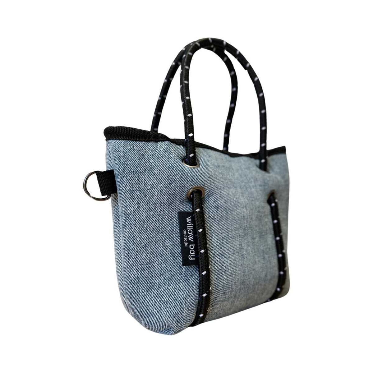 BOUTIQUE TINY Neoprene Tote Bag With Zip - BLUE DENIM-Willow Bay BOUTIQUE TINY Neoprene Tote Bag - Blue Denim The newest addition to the Boutique Family, meet the Tiny! This bag is seriously cool. The perfect companion when needing to store only your essentials. It will comfortably fit your phone, lippy, purse and keys and comes with a cool detachable crossbody strap so it can be used as a cute mini bag and/or a crossbody bag.
The Tiny has the same signature full closure zip as our Boutique and Boutique Mi